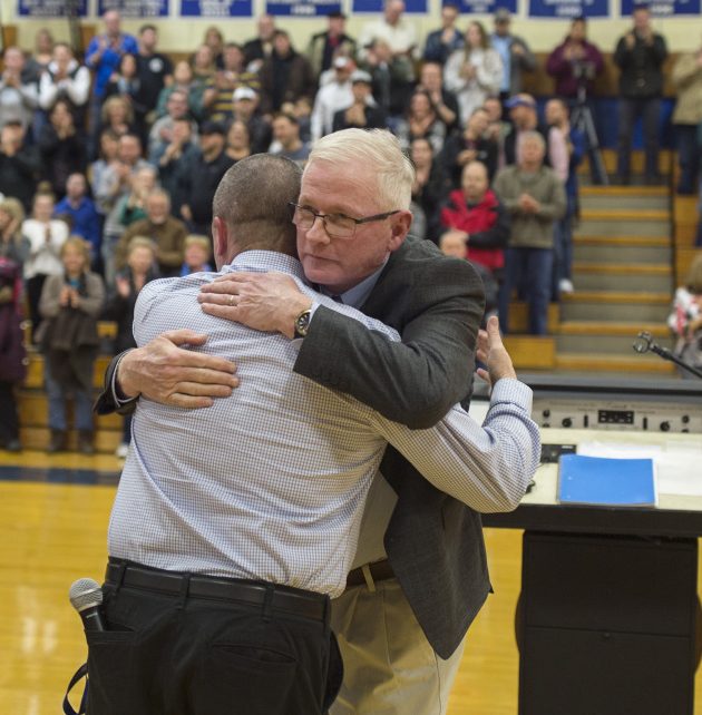 John Regan, who coached Old Orchard Beach's boys' basketball team for 21 seasons, hugs Dean Plante, a former player and now OOB's athletic director, at a gym dedication ceremony Thursday night. Regan guided the Seagulls to the school's only basketball state championship, winning the Class C title in 1988.