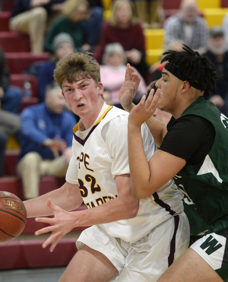 Cape Elizabeth center Andrew Hartel drives to the basket against Dominick Campbell during Waynflete's 53-52 win.