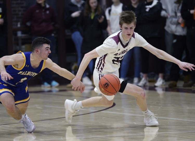 Nicco Pitre of Falmouth, left, and Andrew Storey of Greely compete for a loose ball Friday night during Greely's 46-29 victory at Cumberland. The Rangers were coming off their first loss in three seasons.