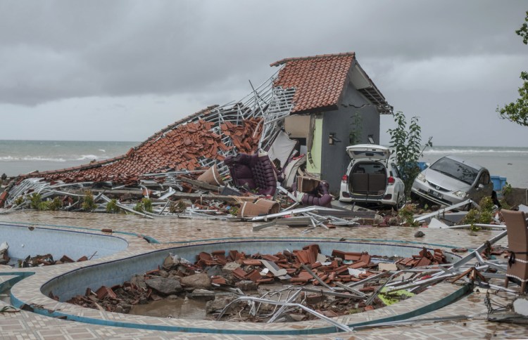 Debris litters a property badly damaged by a tsunami in Carita, Indonesia, on Sunday after the eruption of a volcano around the Sunda Strait during a busy holiday weekend.