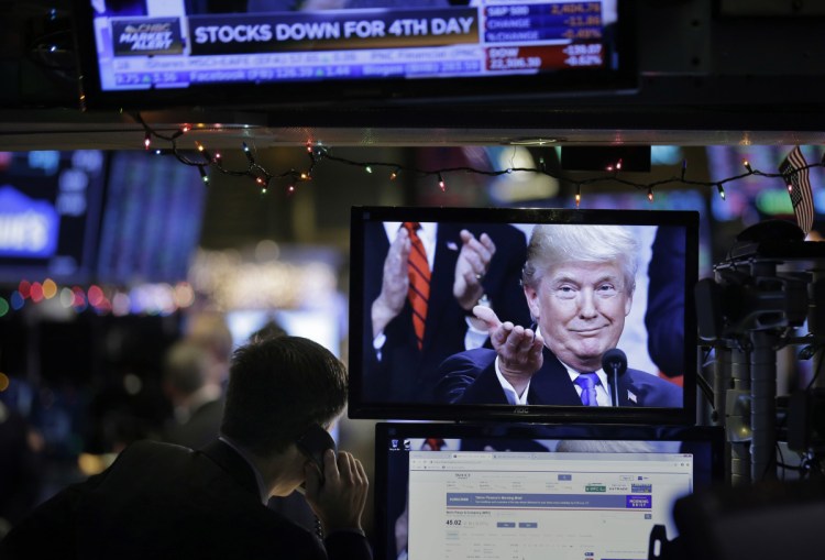 A picture of President Trump is displayed on a computer on the floor of the New York Stock Exchange in New York on Monday.