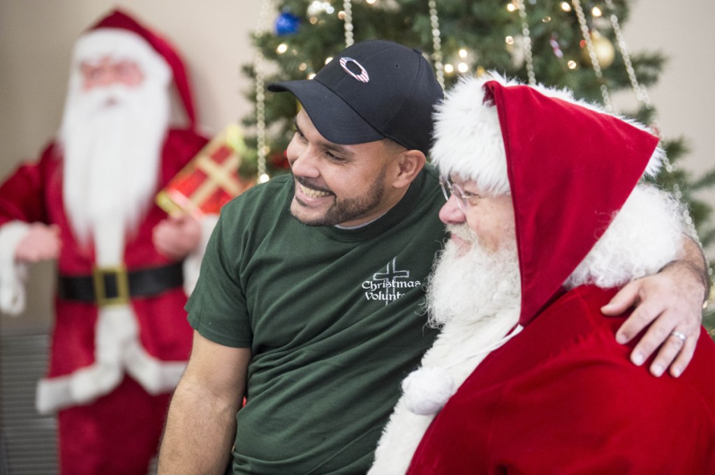 ABOVE: Santa Claus gets some positive feedback and a photo with volunteer, Oscar Camarena.