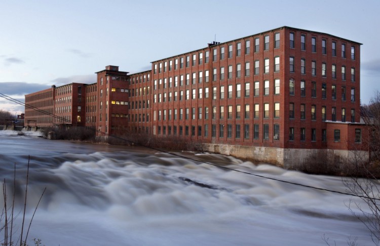 The Presumpscot River flows past the Dana Warp Mill complex in Westbrook in December 2009. A New Hampshire developer purchased the 246,000-square-foot structure this month for $5.1 million, about double what the building sold for in 2011.