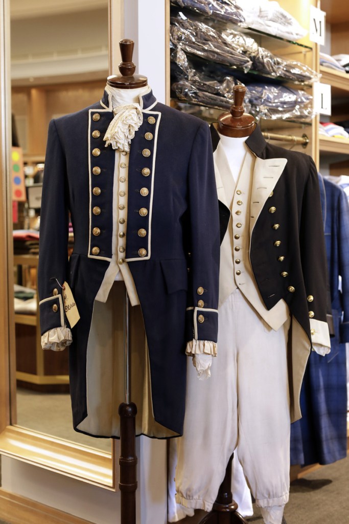 Costumes from "Mutiny on the Bounty," Marlon Brando's 1962 outfit on the left and Charles Laughton's 1935 outfit on the right, are displayed at Carroll & Co. in Beverly Hills. The 70-year-old clothing store in Beverly Hills that has catered to celebrities and the affluent, will be shutting down early next year.