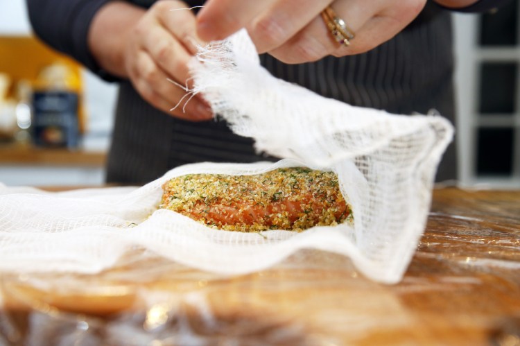 Rudalevige wraps the salmon in cheesecloth to make gravlax.