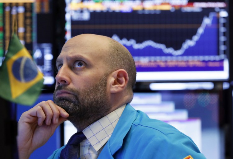 Specialist Meric Greenbaum works the floor Friday at the New York Stock Exchange.