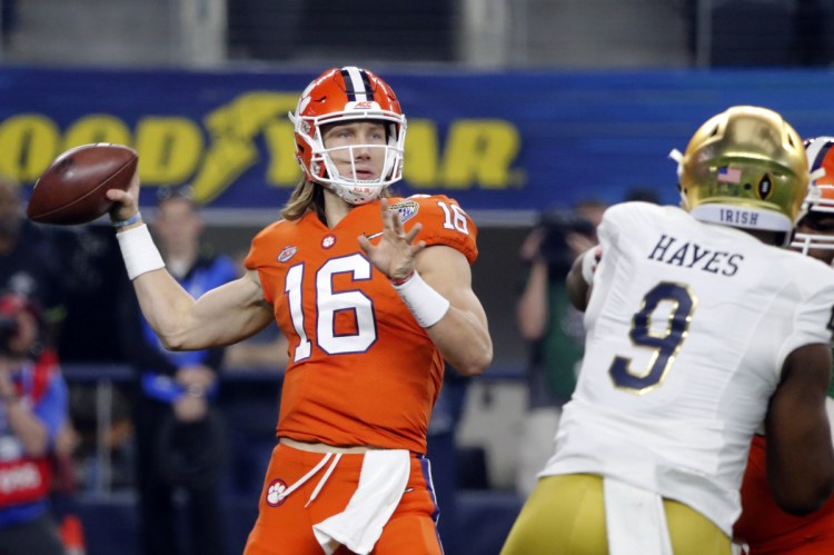 Clemson quarterback Trevor Lawrence threw for 327 yards and three touchdowns to lead the Tigers over Notre Dame on Saturday in Arlington, Texas.