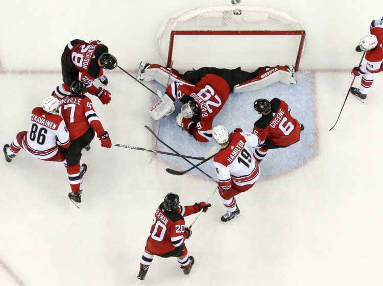 New Jersey Devils goaltender MacKenzie Blackwood lies on the puck Saturday after making a save during the first period of the 2-0 victory against the Carolina Hurricanes. Blackwood finished with 37 saves,