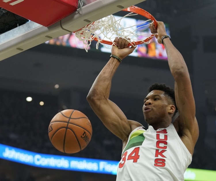Milwaukee's Giannis Antetokounmpo throws down a dunk in the first half of the Bucks' 129-115 win over the Brooklyn Nets on Saturday in Milwaukee. Antetokounmpo had 30 points, 10 rebounds and 10 assists.