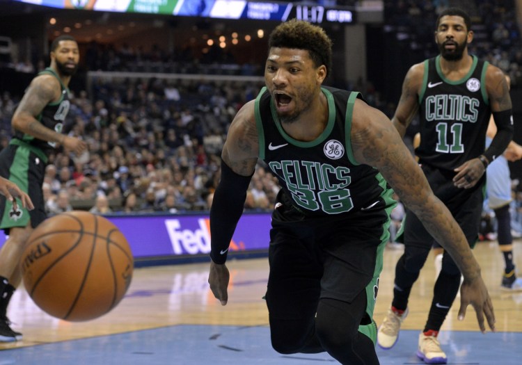 Boston guard Marcus Smart reacts as the bounces out of bounds during the first half of Saturday's game against the Grizzlies in Memphis, Tenn.