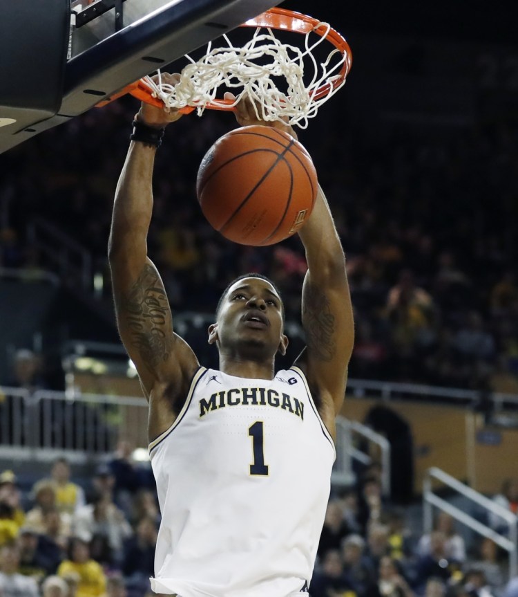 Michigan guard Charles Matthews dunks during the second half of the Wolverines' 75-52 win over Binghamton on Sunday in Ann Arbor, Mich.