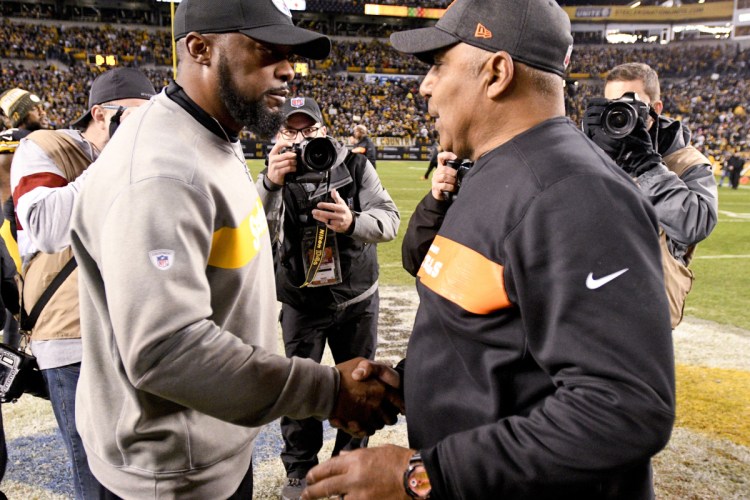 Pittsburgh head coach Mike Tomlin, left, greets Cincinnati head coach Marvin Lewis Sunday night in Pittsburgh. Lewis was fired Monday.