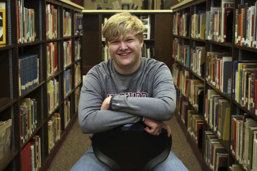 Ulysses High School senior Braxton Moral sits for a portrait in Ulysses, Kan., recently. The 16-year-old will graduate from Harvard around the same time he graduates from high school in May.