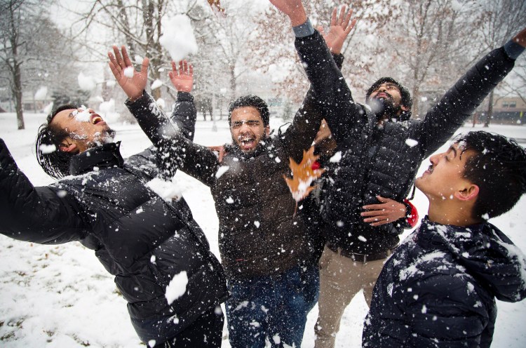 PORTLAND, ME - University of Southern Maine students from Nepal, in their first-ever encounter with snow, throw it all over each other in Portland’s Deering Oaks park. From left are Spadan Khariwoda, Anamol Dhakal, Resham Pandey and Bikash Sharmi. (Photo by Carl D. Walsh/Staff Photographer)