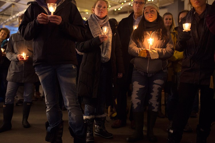 People gather Friday evening at Preble Street for a vigil honoring the 36 people in the homeless community who died in 2018. The vigil is held every year on the longest night of the year, the winter solstice.