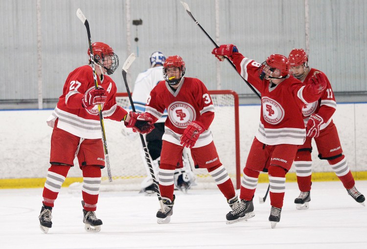 South Portland celebrates a goal against York Thursday night. Left to right: Willets Meyer, Cullen Adams, Bradley McMains and in the right background Ian Souther. 