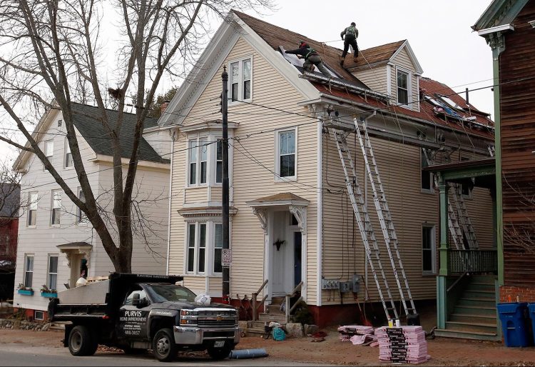 Purvis Home Improvements of Saco appeared to be back at work at 157 Congress St. in Portland on Friday, a day after a worker died in a fall from the roof.