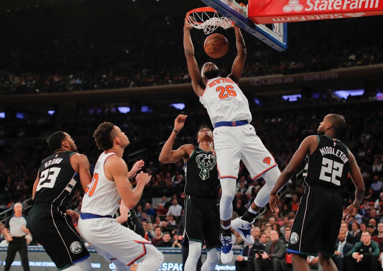New York Knicks center Mitchell Robinson (26) dunks against the Milwaukee Bucks during the first quarter Saturday in New York.