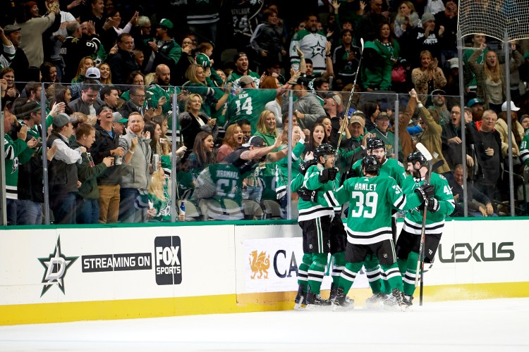 Dallas Stars center Mattias Janmark (13) celebrates with teammates after scoring a goal against the San Jose Sharks on Friday in Dallas.