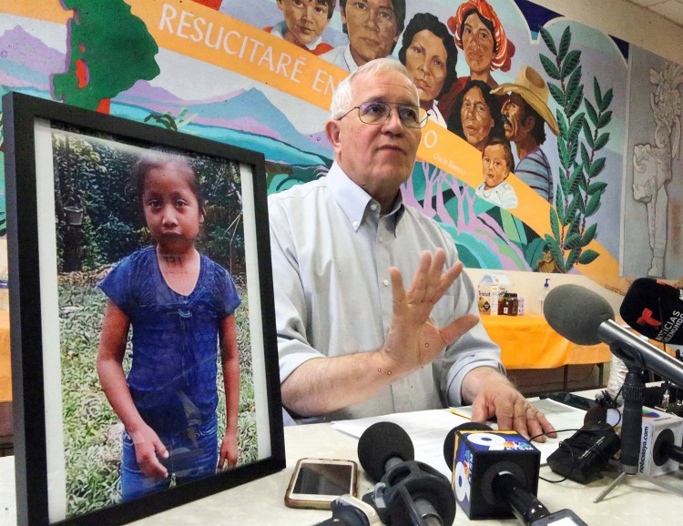 Annunciation House director Ruben Garcia answers questions from the media after reading a statement from the family of Jakelin Caal Maquin, pictured at left, during a news briefing at Casa Vides on Saturday in downtown El Paso, Texas. Maquin had received her first pair of shoes several weeks ago, when her father said they would set out together for the U.S., thousands of miles from her impoverished Guatemalan village. Instead she died in a Texas hospital two days after being taken into custody by U.S. Border Patrol agents in a remote stretch of New Mexico desert. 