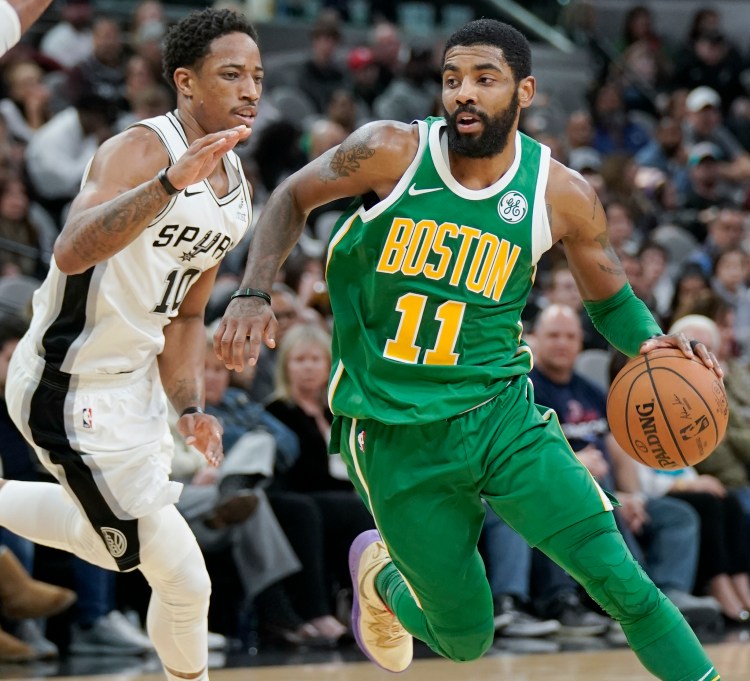 Boston's Kyrie Irving drives against San Antonio Spurs' DeMar DeRozan during the second half of the Celtics' 120-111 loss on Monday in San Antonio.
