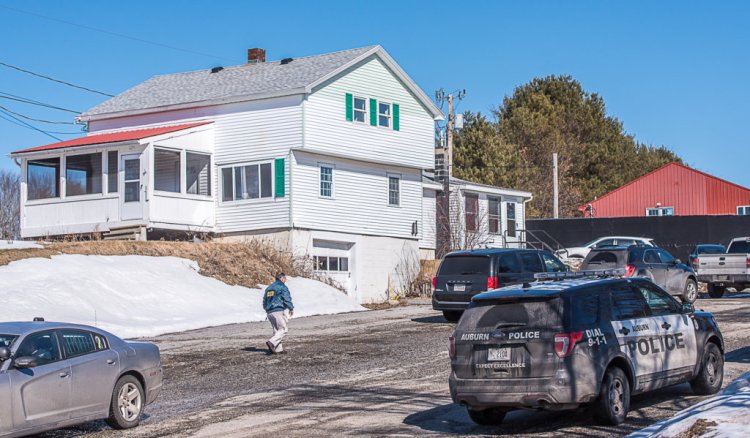 An IRS investigator walks up the driveway of Tyler Poland's home and office on Merrow Road in Auburn during the February drug bust in Lewiston and Auburn.