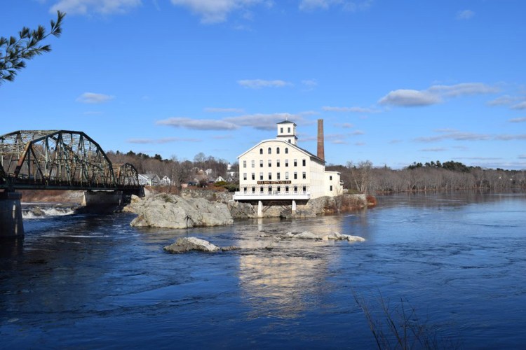 Brunswick firefighters pulled a woman from the Androscoggin River on Wednesday.