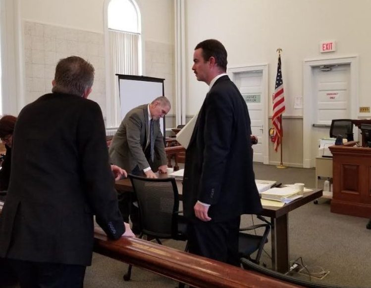 James "Ted" Sweeney, center, is on trial on a charge of murder in the death of his former girlfriend, Wendy Douglass, 51, of Jay on July 11, 2017, while she slept at her home. Sweeney's co-defense attorney Thomas J. Carey, right, and a private investigator are seen during a break in the trial Monday in Franklin County Superior Court.