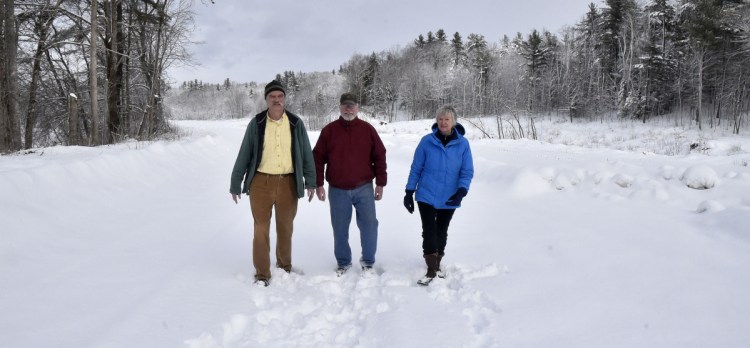 Morning Sentinel photo by David Leaming
Members of the Somerset Woods Trustees, from left, Ernie Hilton, Jack Gibson and Nancy Williams, on Thursday walk on the Weston Homestead Farm property along the Kennebec River in Madison that the trust is acquiring and will make available to the public for recreation.