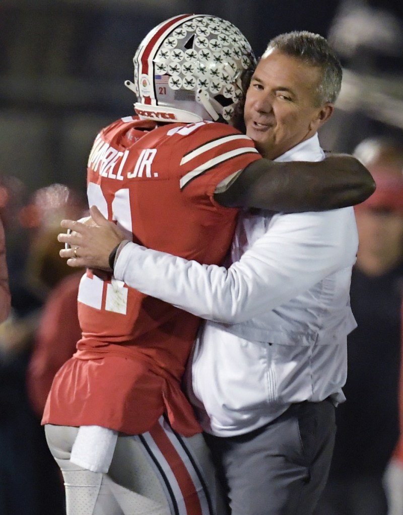 Ohio State Coach Urban Meyer, right, hugs wide receiver Parris Campbell after the Buckeyes won the Rose Bowl 28-23 win over Washington.