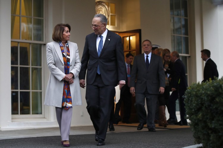 House Democratic leader Nancy Pelosi of California, left, walks with Senate Minority Leader Chuck Schumer, D-N.Y., as Democratic leaders including Sen. Dick Durbin, D-Ill., at right, arrive to speak to the media after meeting with President Trump on border security on Wednesday at the White House in Washington. (AP Photo/)