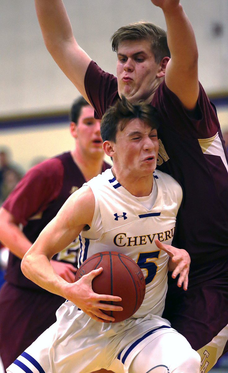 Owen Burke of Cheverus collides with Thornton Academy's Dylan Griffin during a Class AA basketball game Wednesday night in Portland. Griffin scored nine straight points during a decisive run in the third quarter, leading unbeaten Thornton to a 54-29 win.