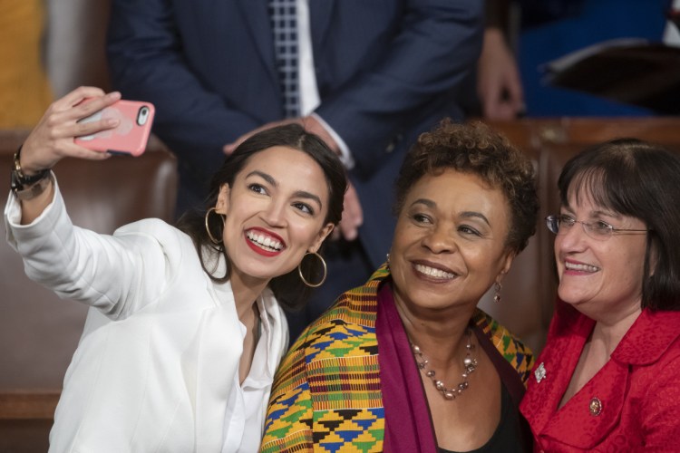 Rep.-elect Alexandria Ocasio-Cortez, a freshman Democrat representing New York's 14th Congressional District, takes a selfie with Rep. Ann McLane Kuster, D-N.H., and Rep. Barbara Lee, D-Calif., on the first day of the 116th Congress, in which Democrats now hold the majority in the House, at the Capitol in Washington on Thursday.