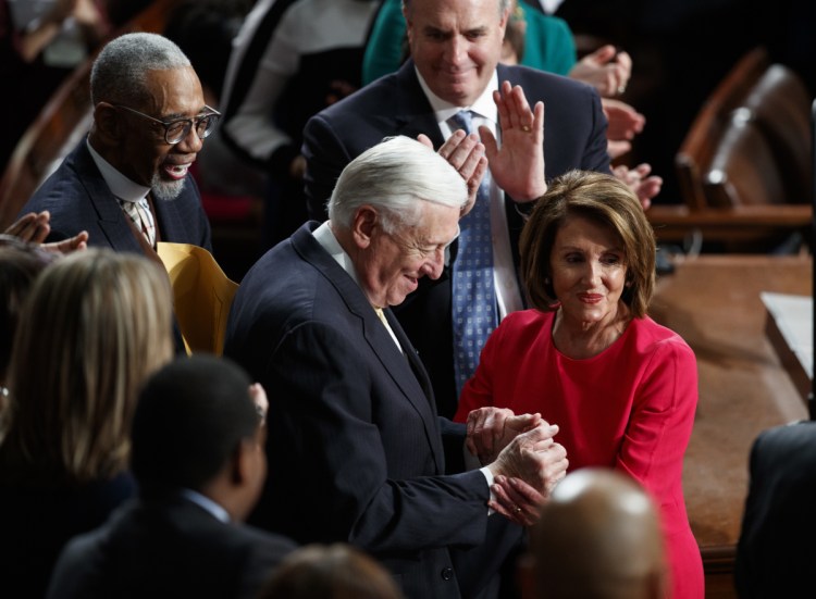 House Democratic Leader Nancy Pelosi of California, who is expected to lead the 116th Congress as speaker of the House, and House Minority Whip Steny Hoyer, D-Md., are applauded at the Capitol in Washington on Thursday.
