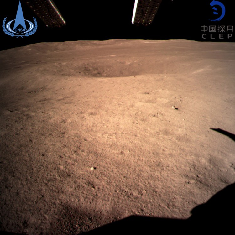 One of the first photographs from China's Chang'e 4 spacecraft shows a small crater. The landing is the first in history on the 'dark' side of the moon.