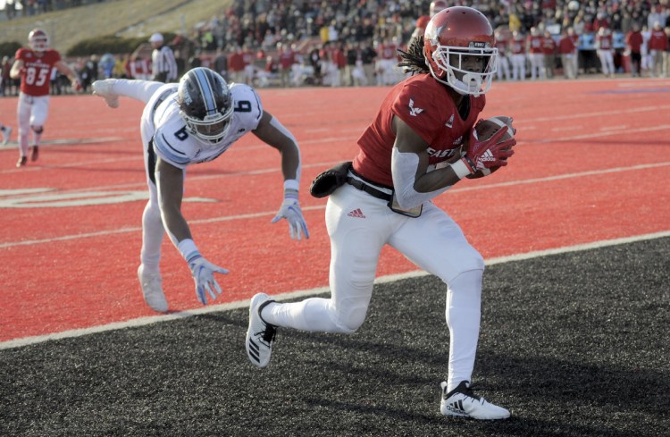 Eastern Washington'S Nsimba Webster (5) scores a touchdown against Maine defender Kayon Whitaker (9) during the first half of a college football game on Saturday, Dec. 15, 2018, in Cheney, Wash. (Kathy Plonka/The Spokesman-Review via AP)