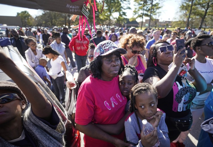 People attend a community rally outside Walmart, on Saturday in Houston for 7-year-old Jazmine Barnes, who was fatally shot Dec. 30 while riding in a car with her mother and three sisters.