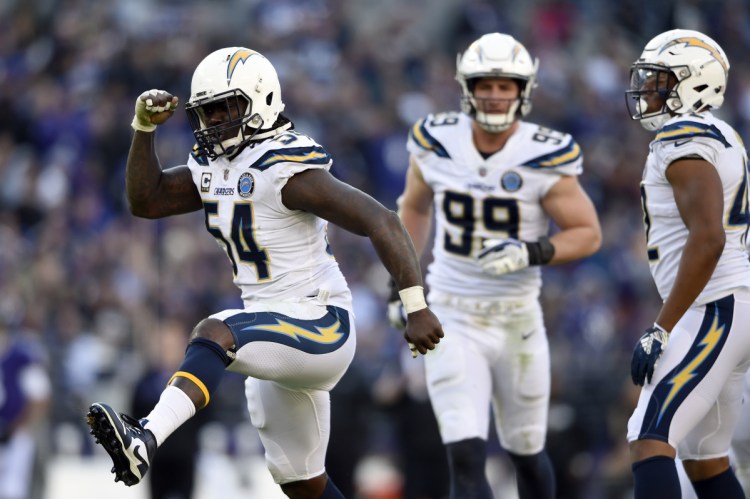 Los Angeles Chargers defensive end Melvin Ingram, left, celebrates after sacking Baltimore Ravens quarterback Lamar Jackson in the second half of the Chargers' 23-17 win in an AFC wild-card game Sunday in Baltimore.