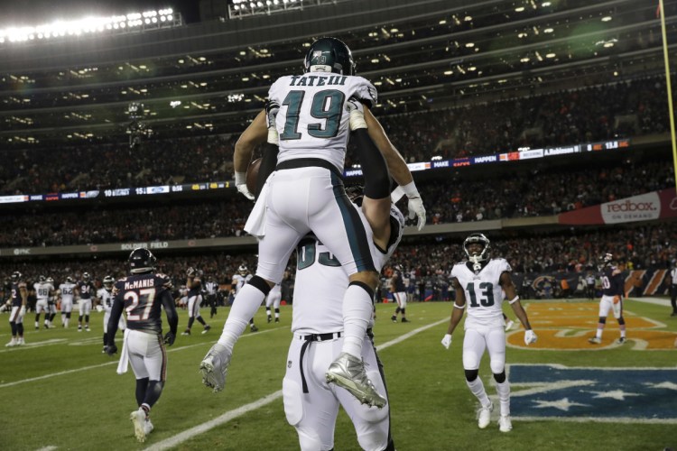 Eagles receiver Golden Tate is hoisted by offensive tackle Lane Johnson after catching the go-ahead touchdown pass with less than a minute remaining Sunday, lifting Philadelphia to a 16-15 win over the Chicago Bears.