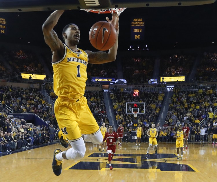 Charles Matthews of Michigan dunks during the first half of a 74-63 victory against Indiana on Sunday at Ann Arbor, Mich. The second-ranked Wolverines improved to 15-0.