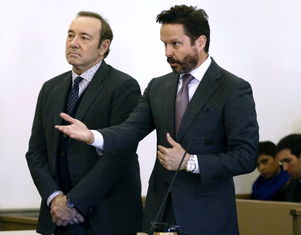 Actor Kevin Spacey stands in district court as his attorney Alan Jackson, right, addresses the judge during arraignment on a charge of indecent assault and battery on Monday in Nantucket, Mass.