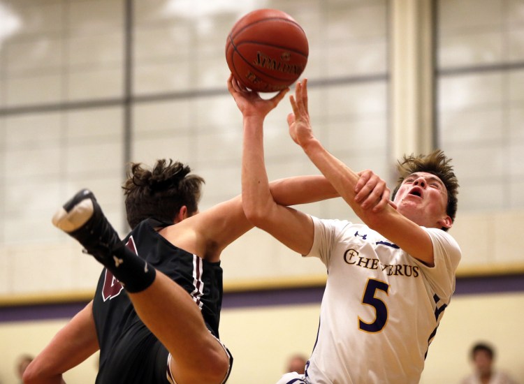 Owen Burke of Cheverus reacts as Henry O'Neill of Gorham goes for a block during Tuesday night's game in Portland. The Stags improved to 6-4 with a 68-64 win.