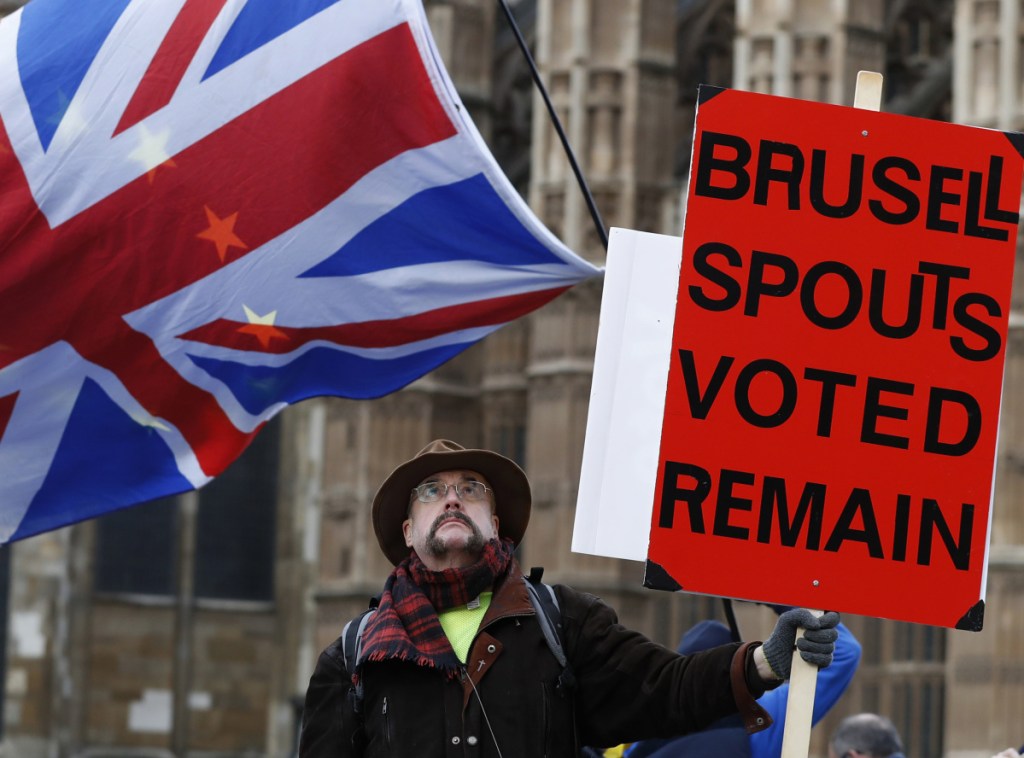 A demonstrator protests in London Wednesday as Parliament debates a Brexit deal that had lacked the votes needed for passage a month ago.