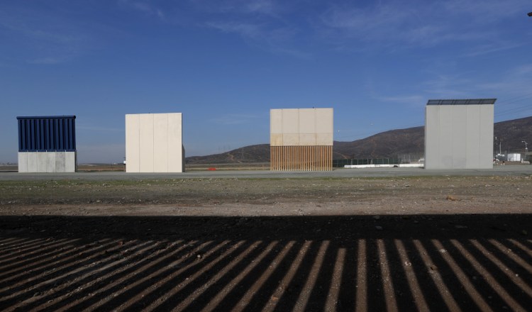 Border wall prototypes stand in San Diego last month near the Mexico-U.S. border. The photo was taken in Tijuana, Mexico, where the current wall casts a shadow in the foreground.