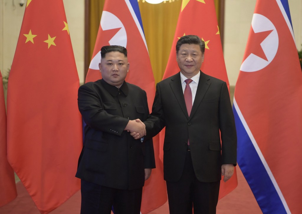 In this Tuesday, Jan. 8, 2019, photo released by China's Xinhua News Agency, North Korean leader Kim Jong Un, left, and Chinese President Xi Jinping shake hands as they pose for a photo before talks at the Great Hall of the People in Beijing. A special train believed to be carrying Kim Jong Un departed Beijing on Wednesday after a two-day visit by the North Korean leader to the Chinese capital. (Li Xueren/Xinhua via AP)