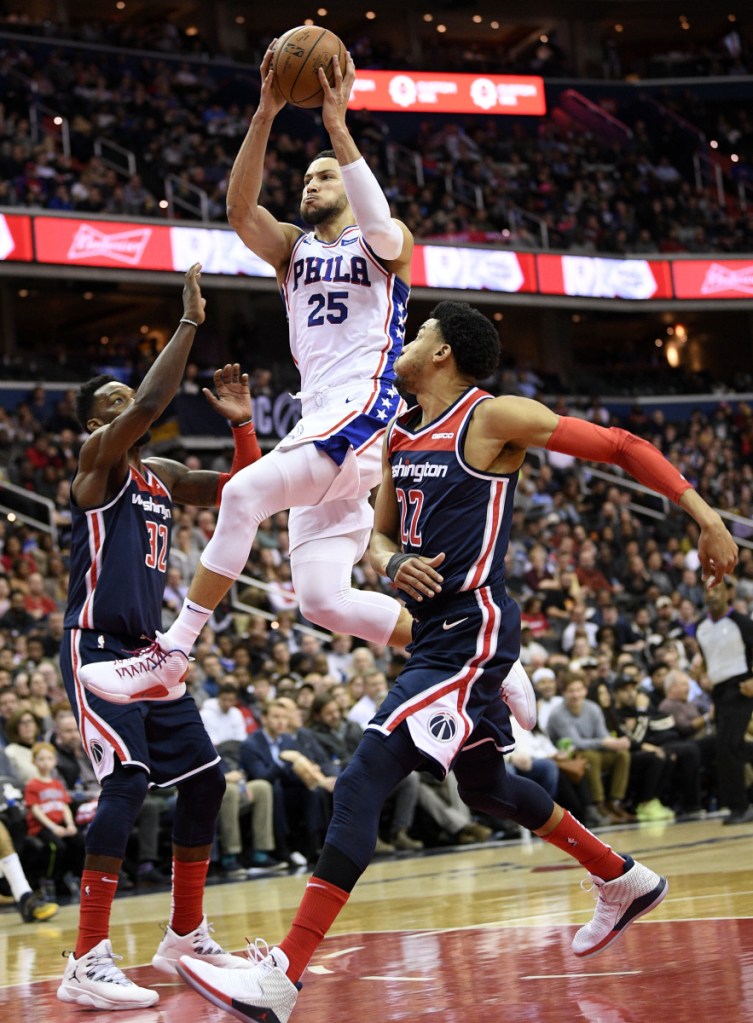 Philadelphia guard Ben Simmons goes to the basket between Otto Porter Jr., left, and Jeff Green of the Wizards during's Wednesday's game in Washington.