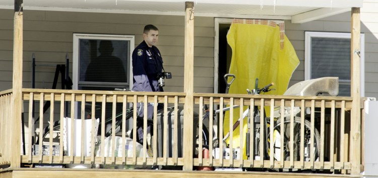 On Jan. 2, state police evidence technicians enter the South Paris apartment where a man and a woman were found dead Jan. 1. Their daughters, a 2-month-old infant and an 8-year-old, were also in the apartment and are now in state custody. Sun Journal photo by Daryn Slover