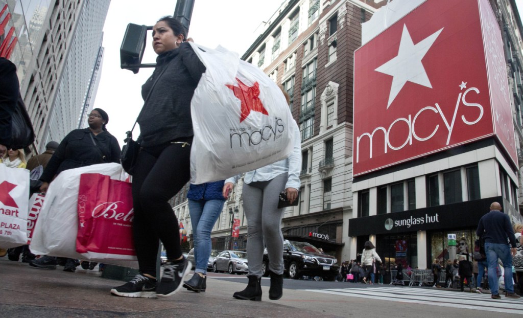 Shoppers cross a walkway near Macy's in New York. Macy's is considered a barometer of consumer spending, particularly for the nation's middle class.