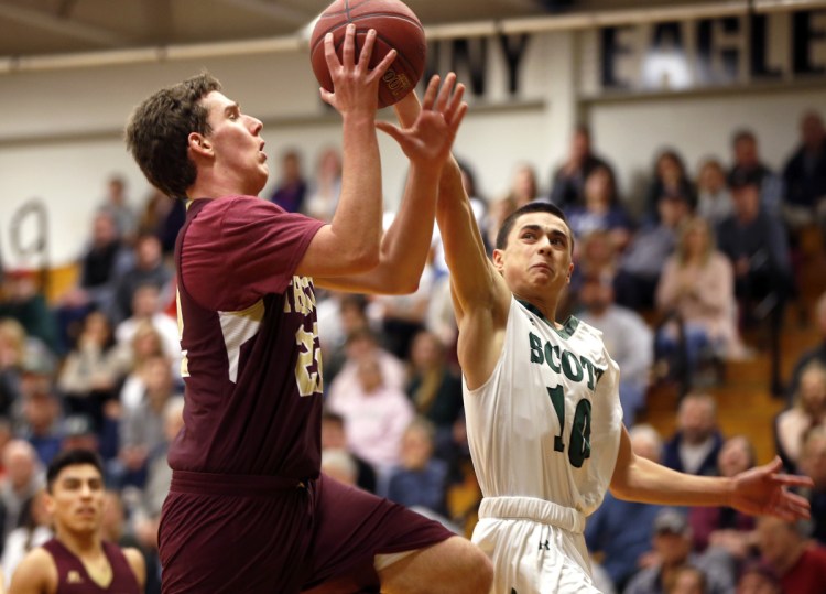 Jack Humphrey, right, of Bonny Eagle, tries to stop a drive to the basket by Thornton Academy's Robert Gawronski during a Class AA South game Thursday in Standish. Gawronski scored 10 points in a 70-62 victory.