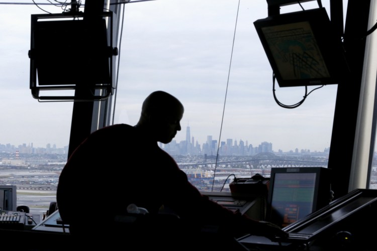 An air traffic controller works in the tower at Newark Liberty International Airport in Newark, N.J., in 2015. 